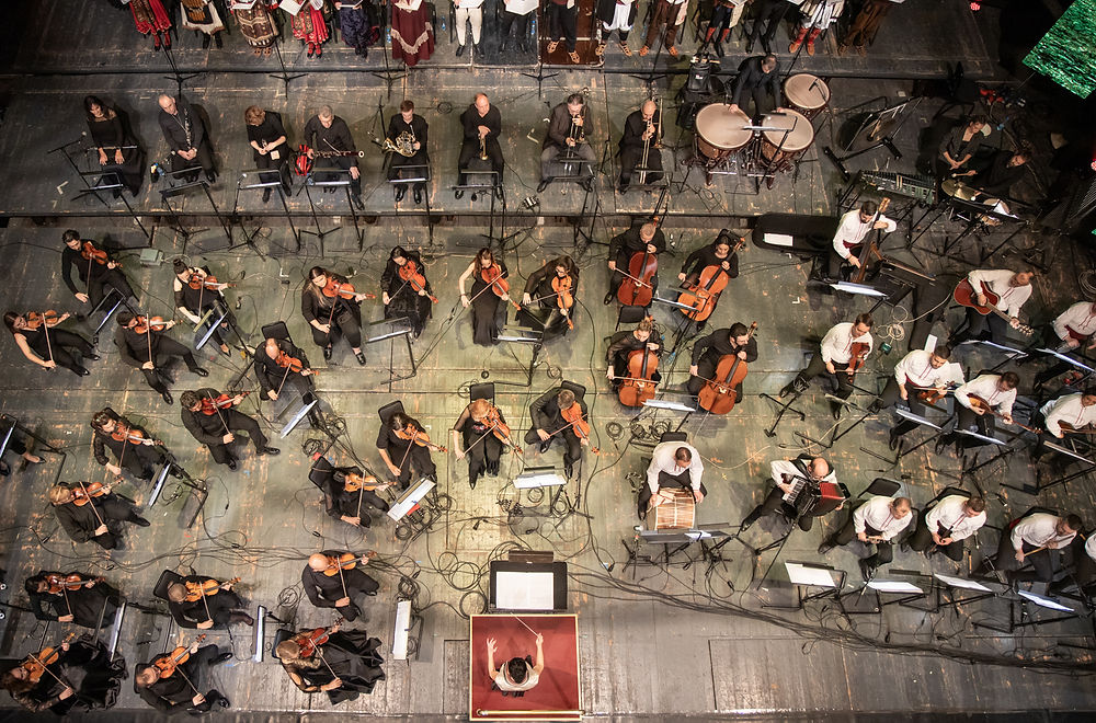 Orchestra seen from above with Bisera Chadlovska conducting from the centre